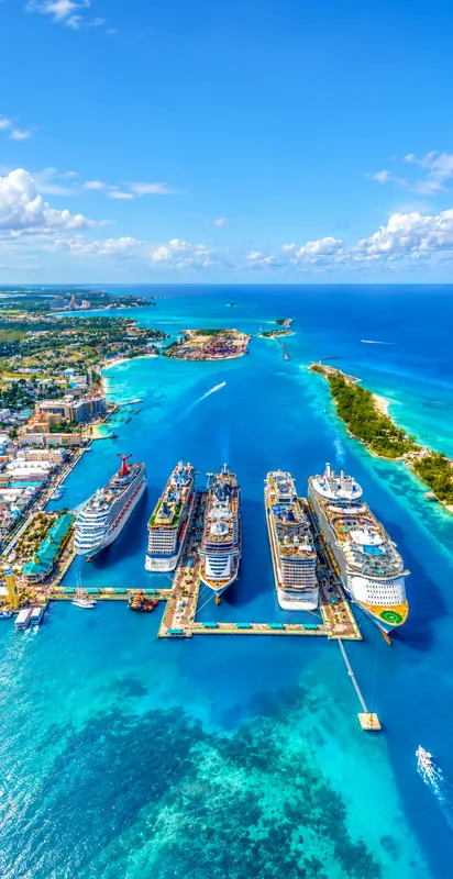 Boats moored beside a Caribbean island surrounded by turquoise water